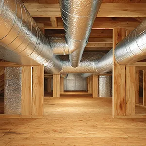 A room filled with metal pipes and wooden floors.