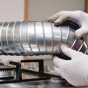 A person in white gloves is holding a silver cup.