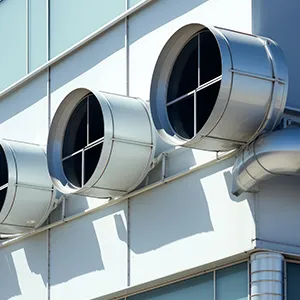A couple of round windows on the side of a building.