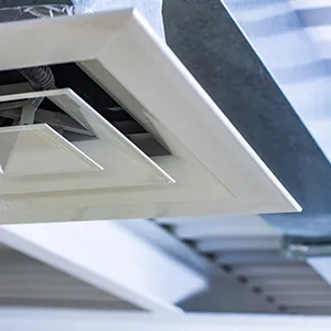 A close up of a ceiling fan in a room.